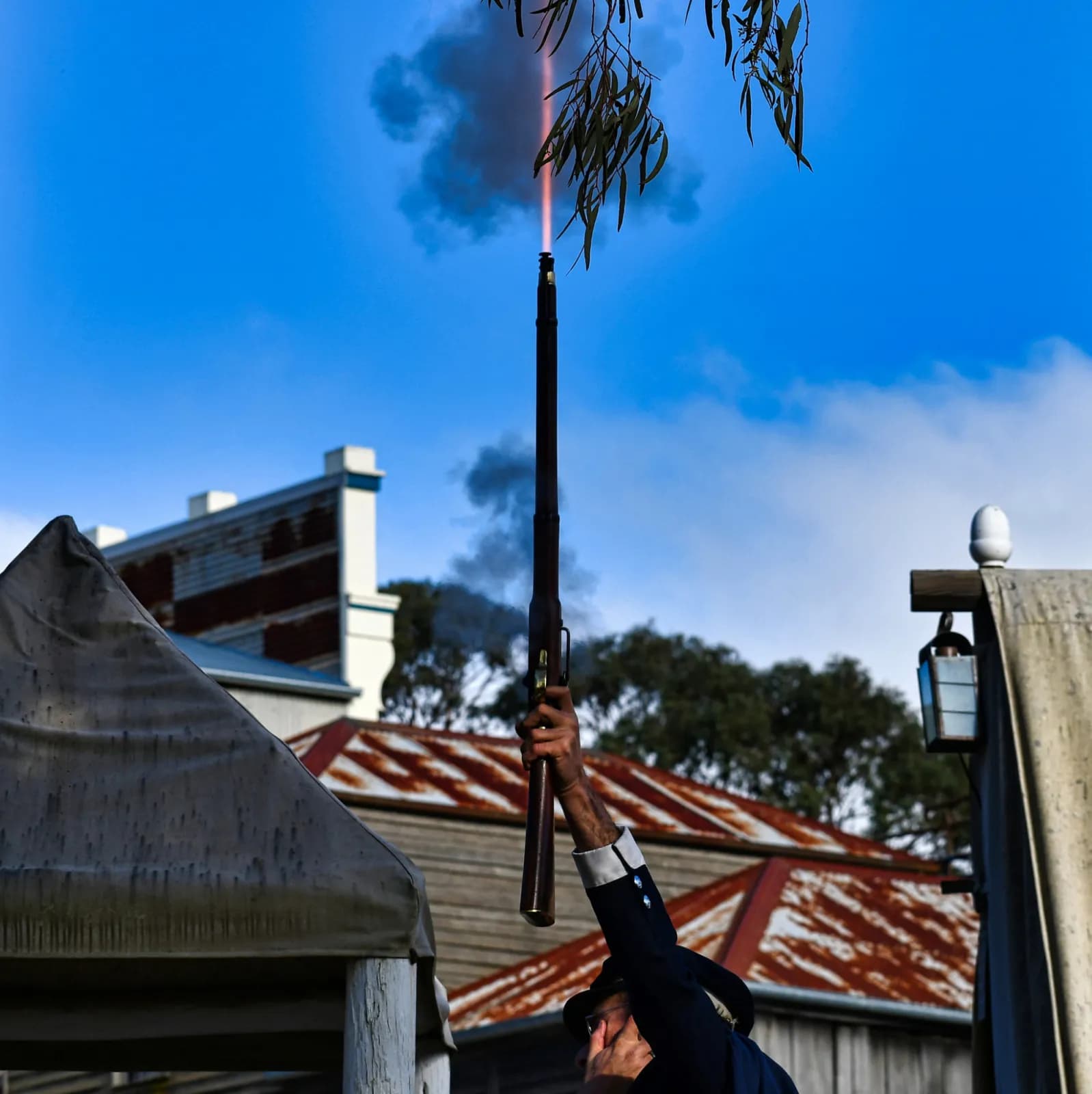 Man firing musket into sky