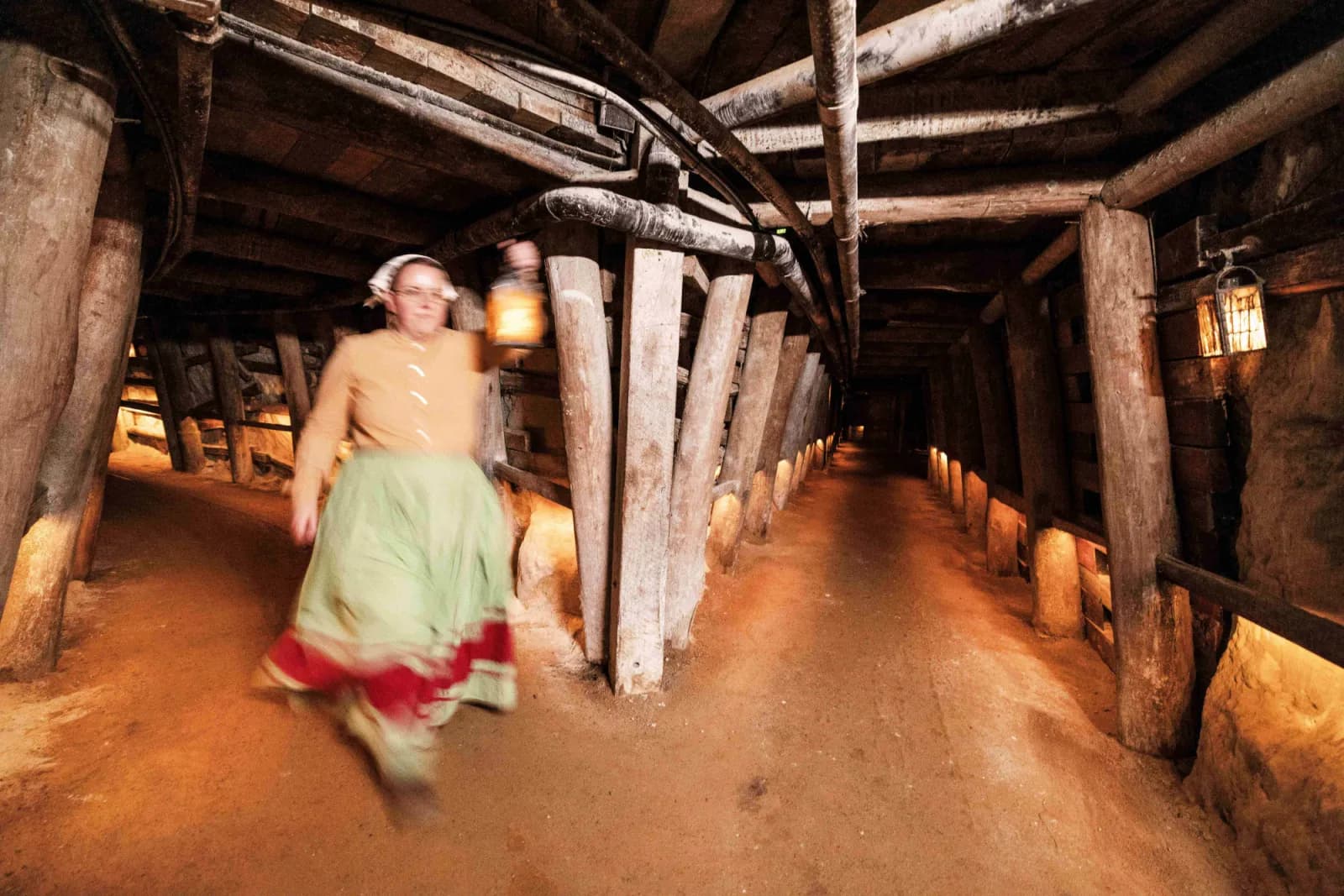 Woman walking in tunnel with light