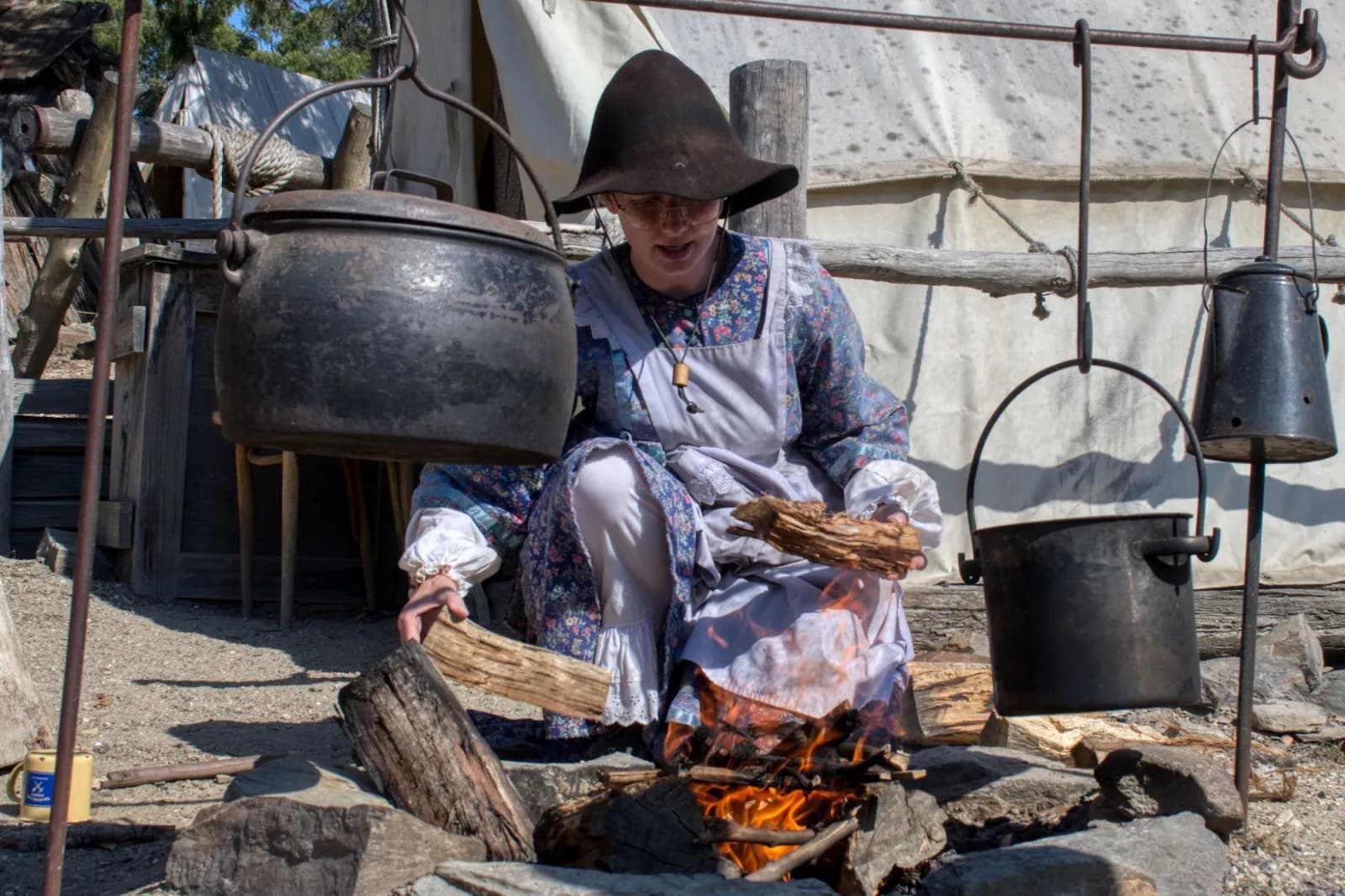 Woman burning logs in a fire