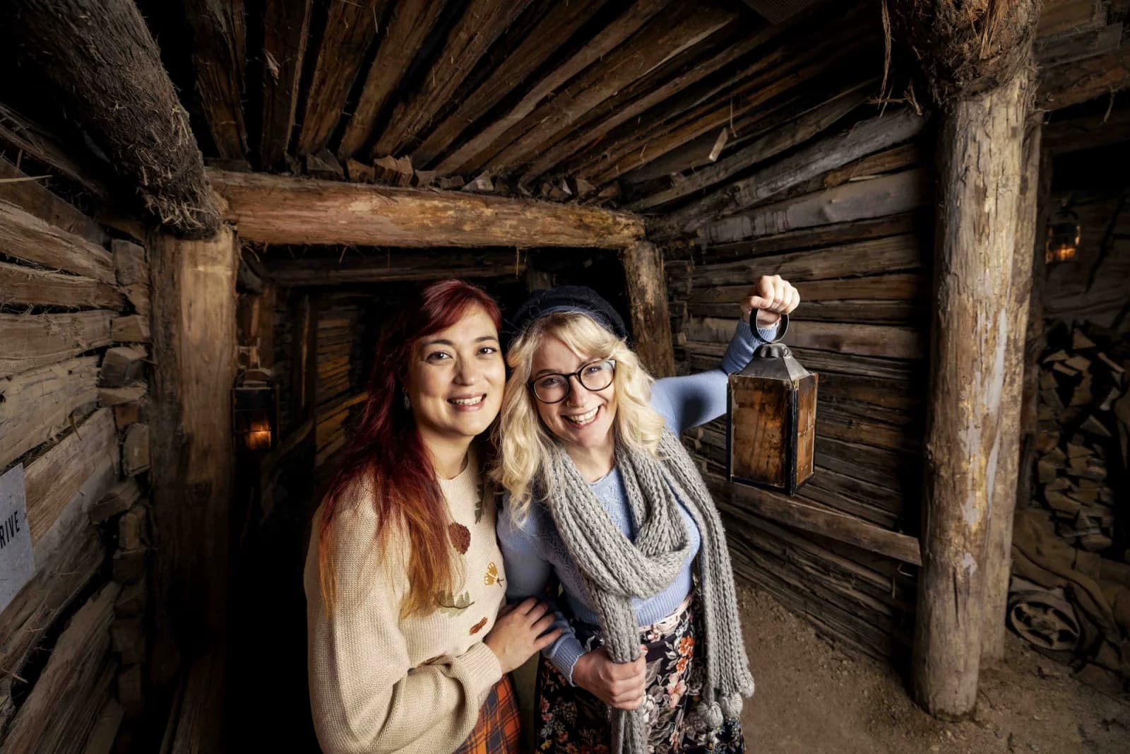 Women holding light in tunnel