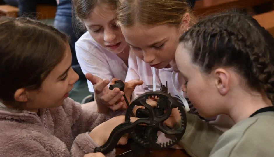 Children playing with a gear