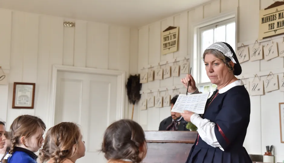 Children learning in a classroom from a teacher