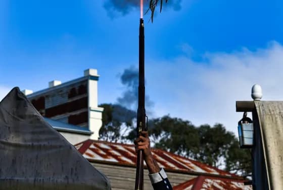 Man firing musket into sky