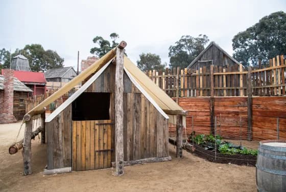Rustic, wooden structure, possibly a tent or hut, in an outdoor setting depicting the Chinese Protectorate Camps