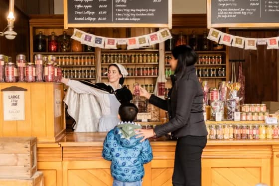 Historic confectionery shop with costumed staff serving visitors sweets and treats, recreating 19th-century experiences, from Australia’s most visited outdoor museum and heritage attraction.