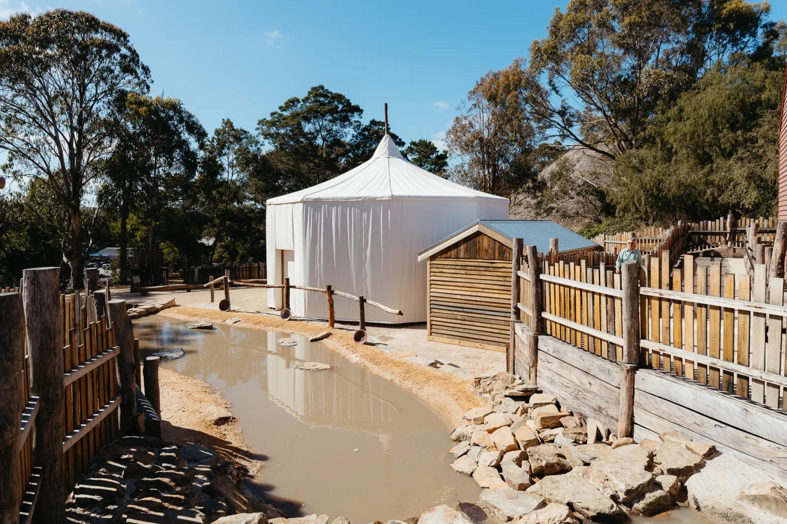 Photograph of a reconstructed historical structure, likely a tent or dwelling from a past era.
