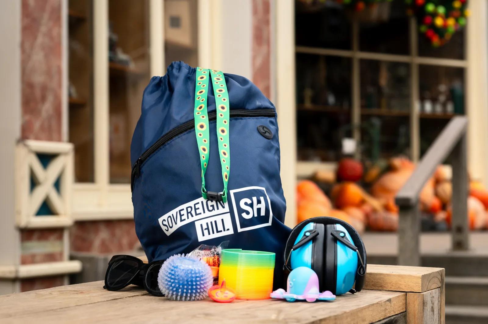 Sovereign Hill branded backpack and sensory-friendly items displayed on a wooden bench, from Australia’s most visited outdoor museum and heritage attraction.