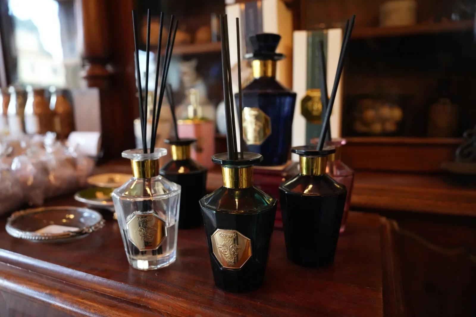 Decorative fragrance diffusers displayed on a polished wooden counter inside Sovereign Hill’s historic apothecary shop.