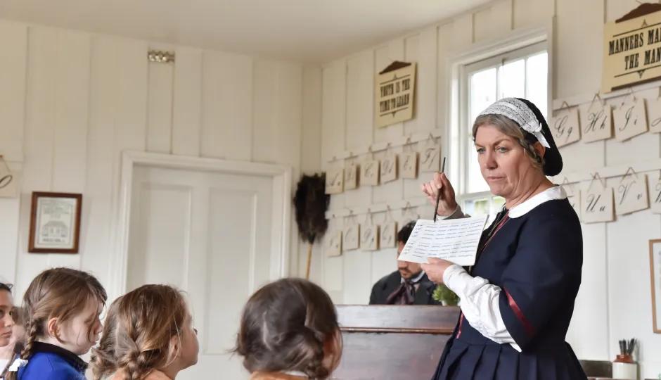 Children learning in a classroom from a teacher