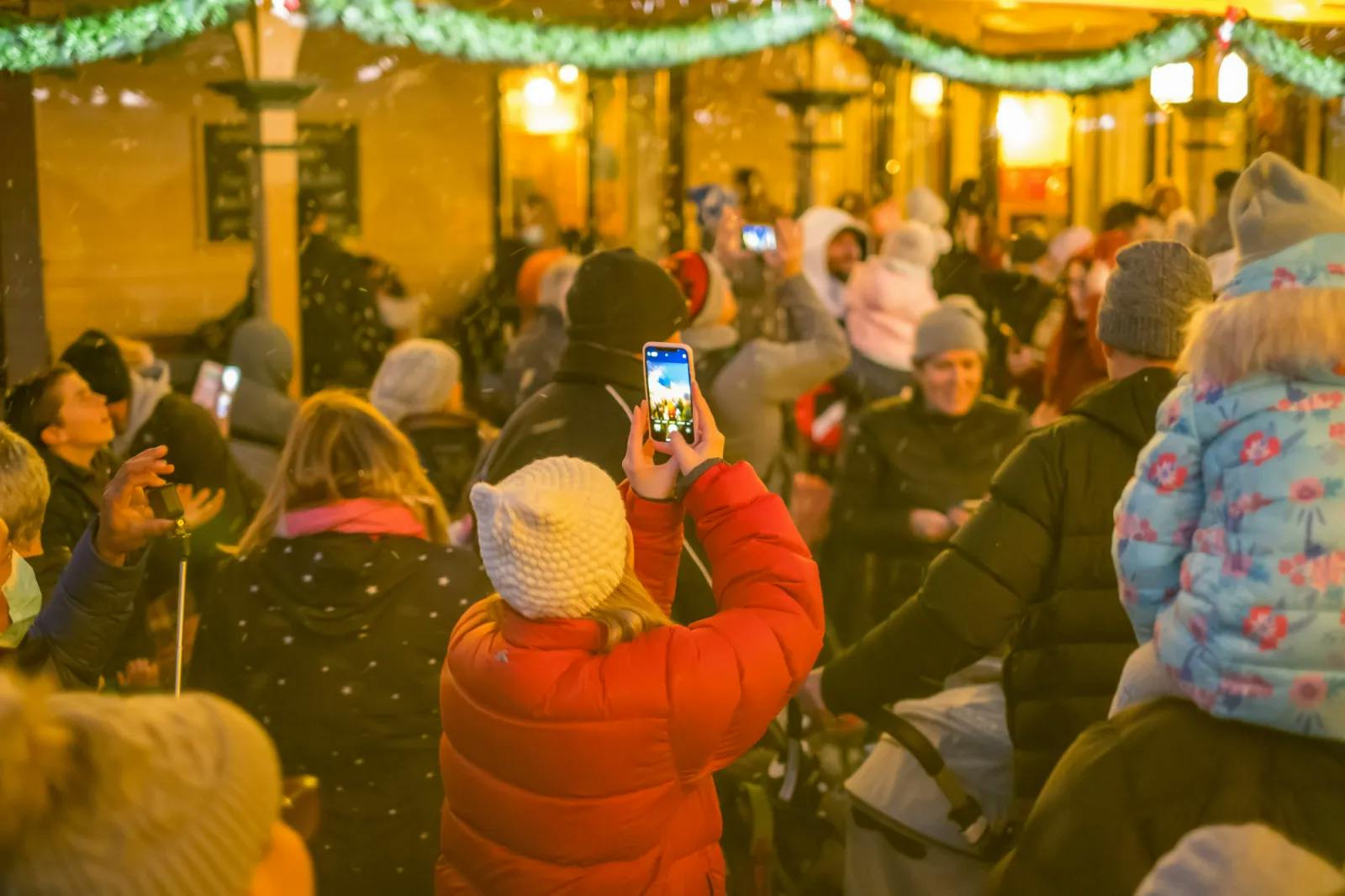 Woman taking a picture at Winter Wonderlights
