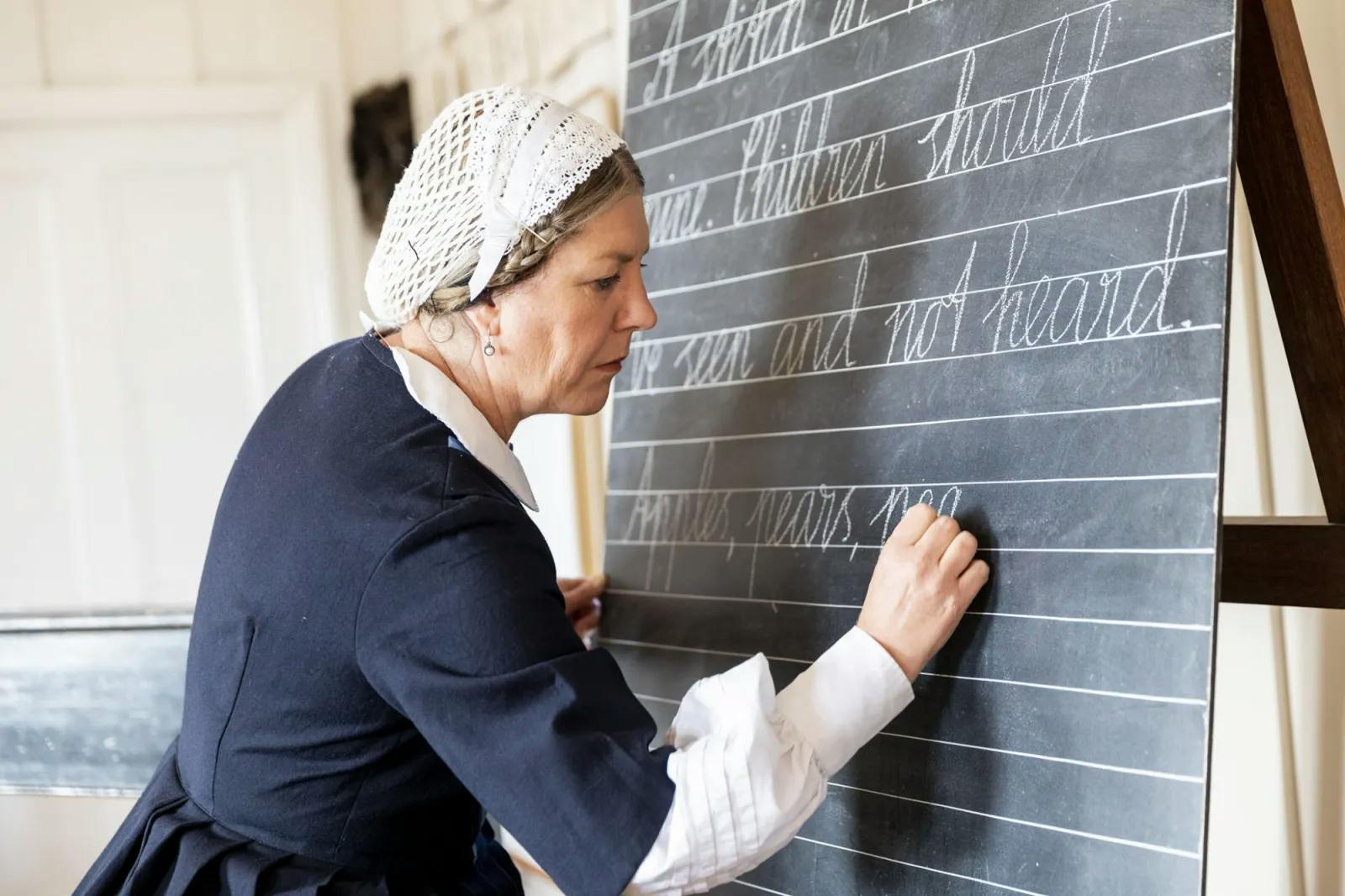 Woman writing on chalk board