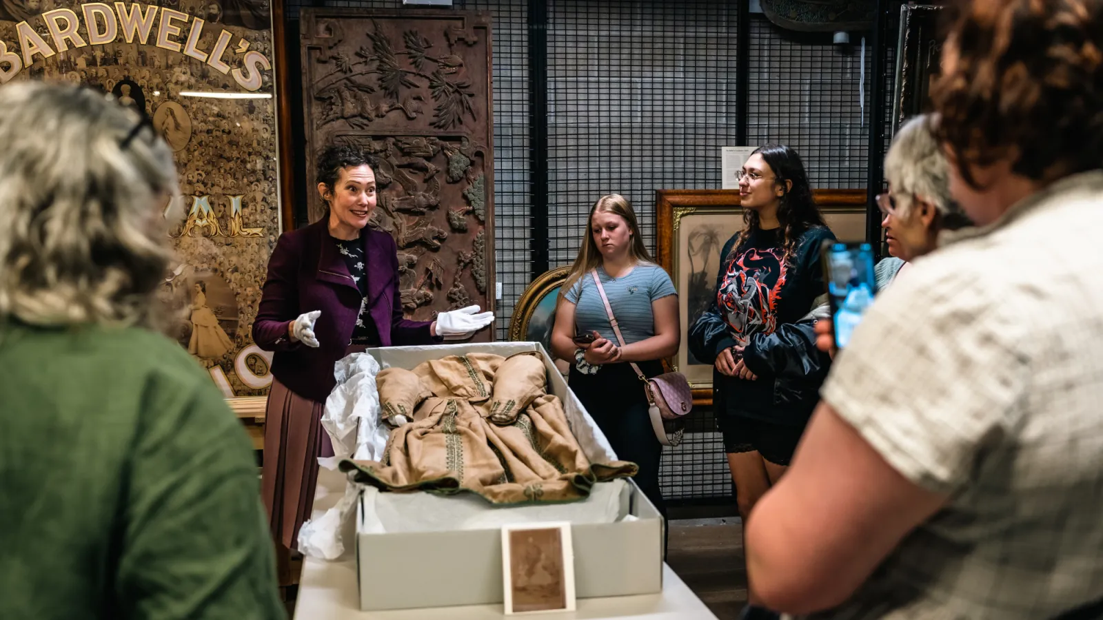 Lady showing a dress to other ladies