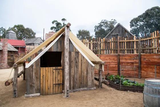 Rustic, wooden structure, possibly a tent or hut, in an outdoor setting depicting the Chinese Protectorate Camps